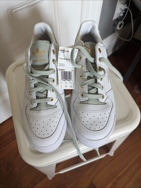 adidas White Sneakers with Light Green Accents and Gold Logo